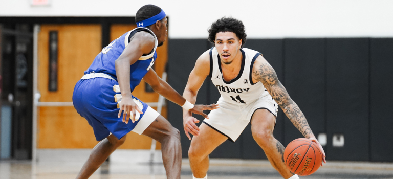 Two basketball players in a game on a court.