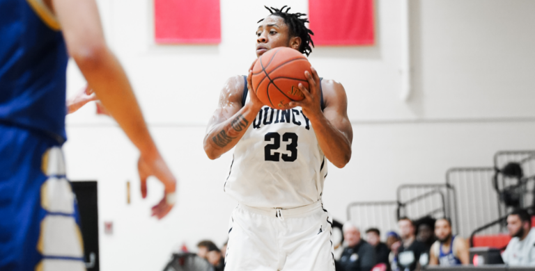 Quincy College student playing basketball