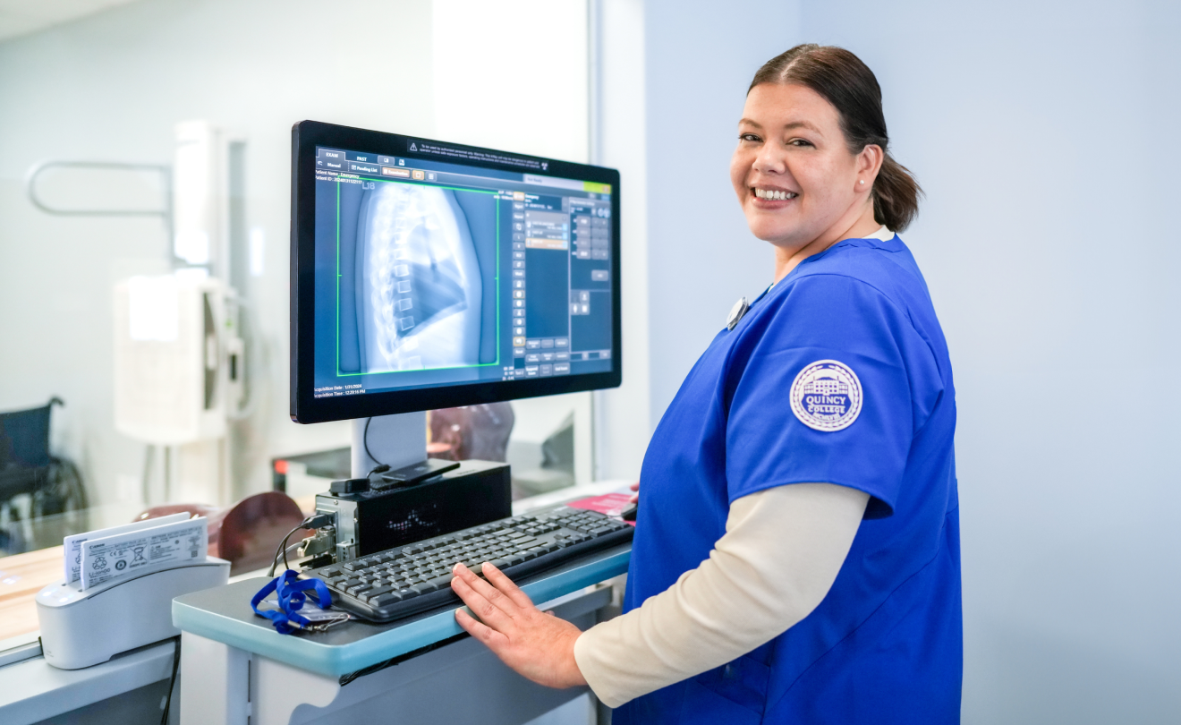 Quincy College Lab Technician looking at x-ray image